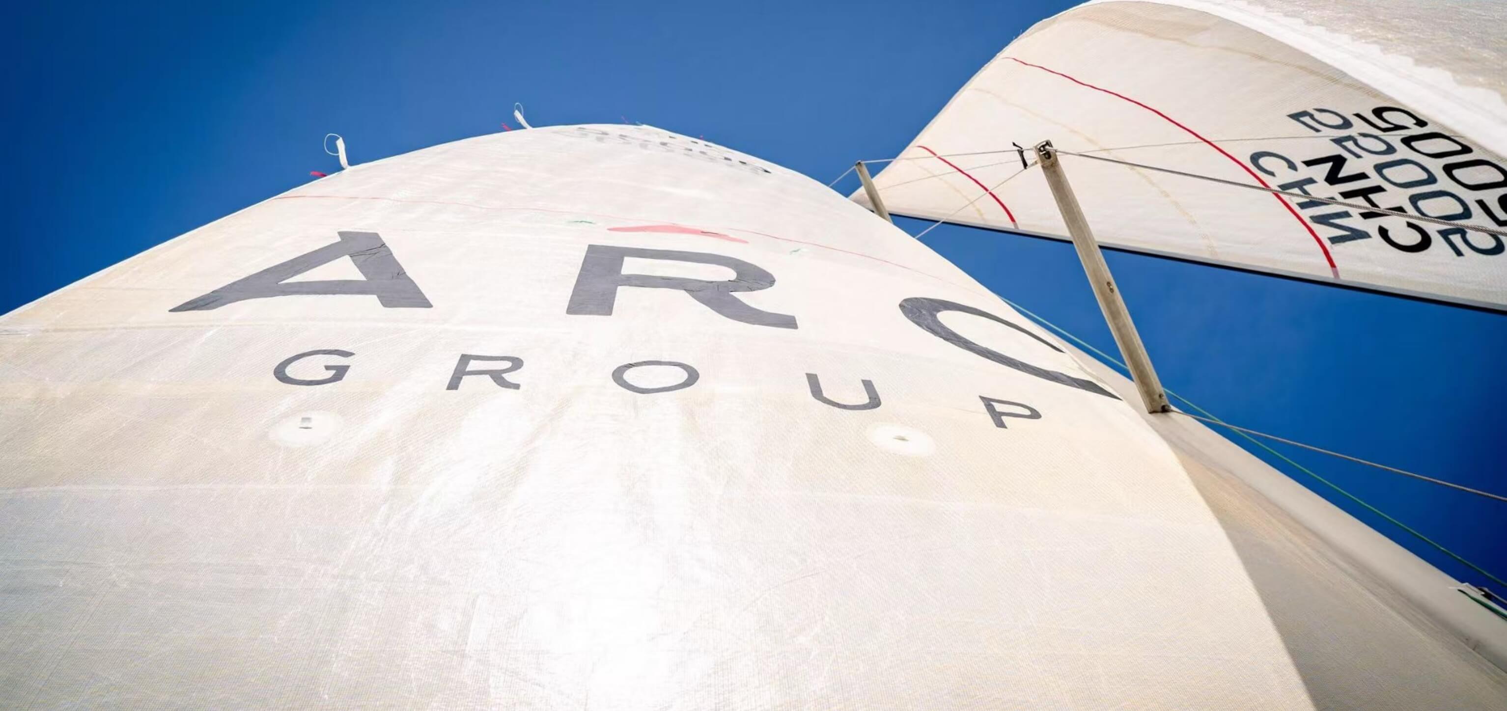A yacht's sail branded with the Alarar Capital Group logo