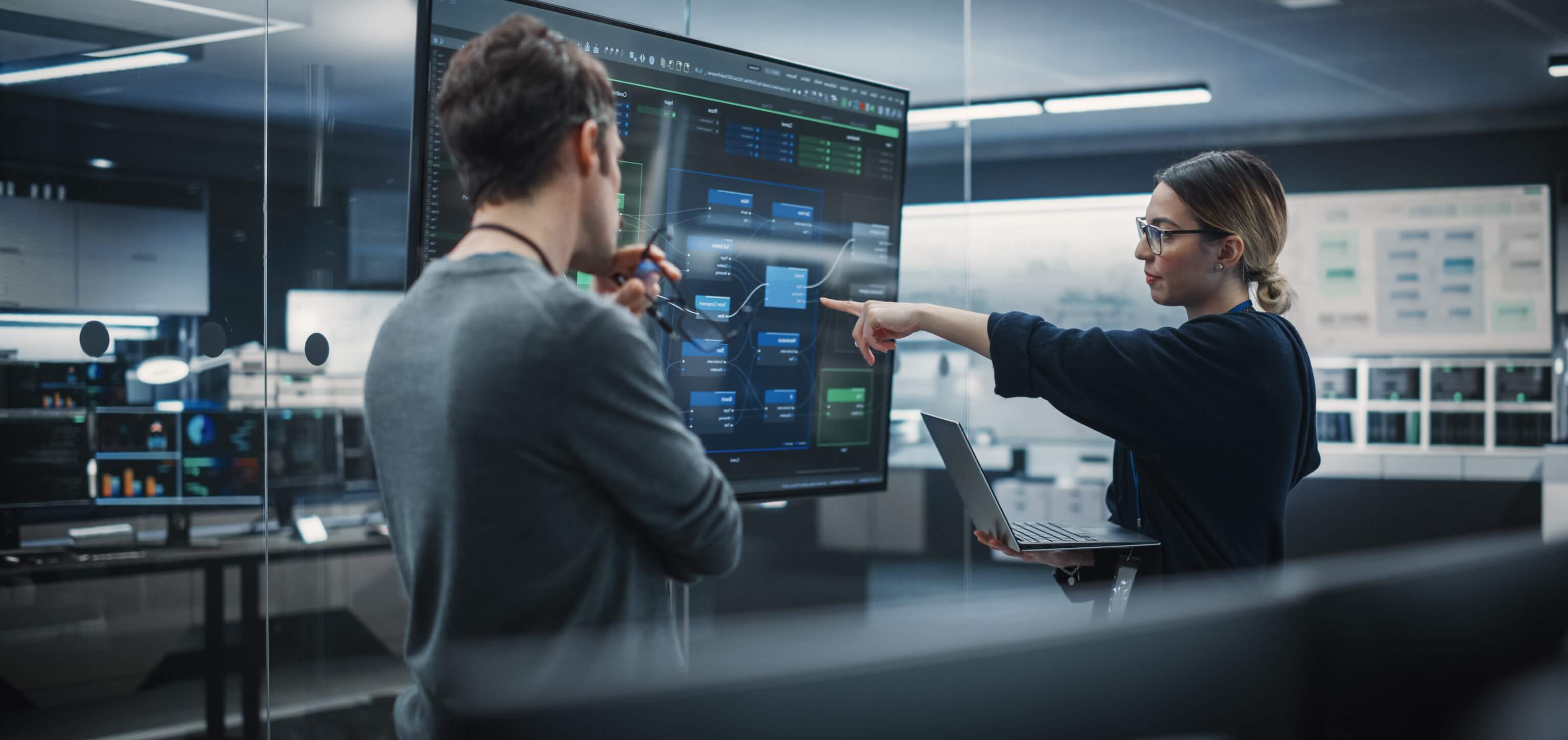 Developers discuss a process on a screen