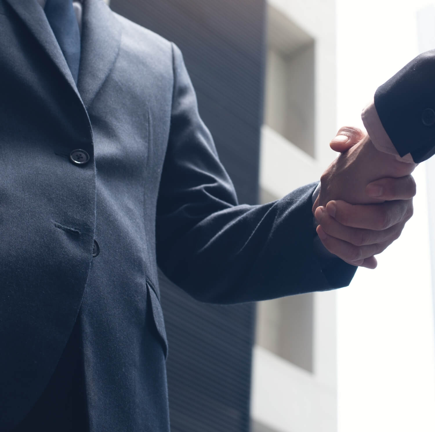 Men in suits shake hands