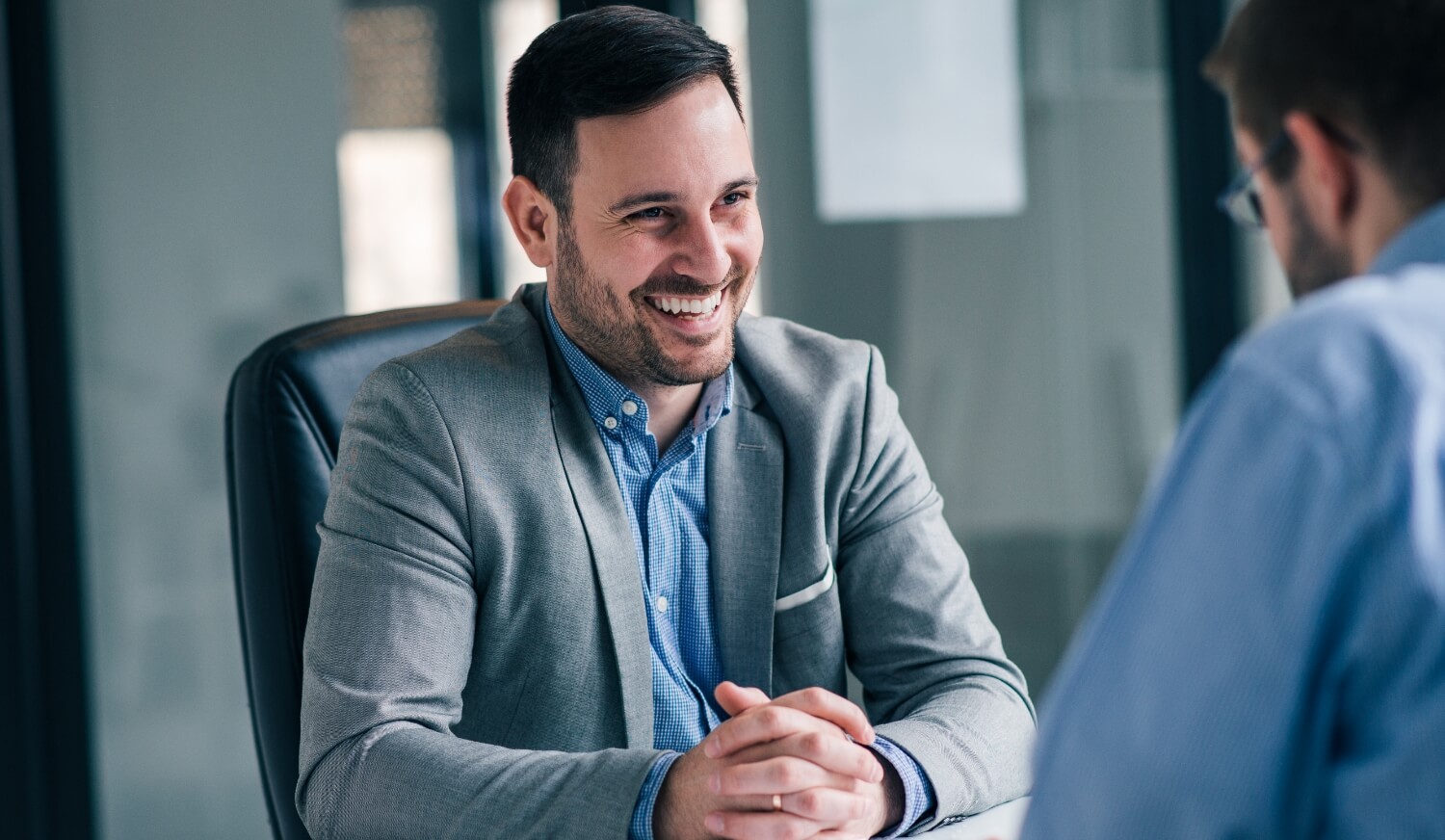 A man laughs during a job interview